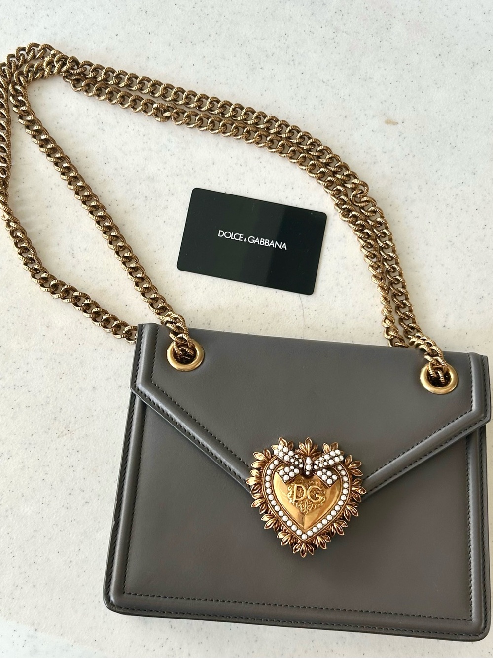 Dolce & Gabbana Gray Leather Shoulder Bag with Gold Heart Emblem.